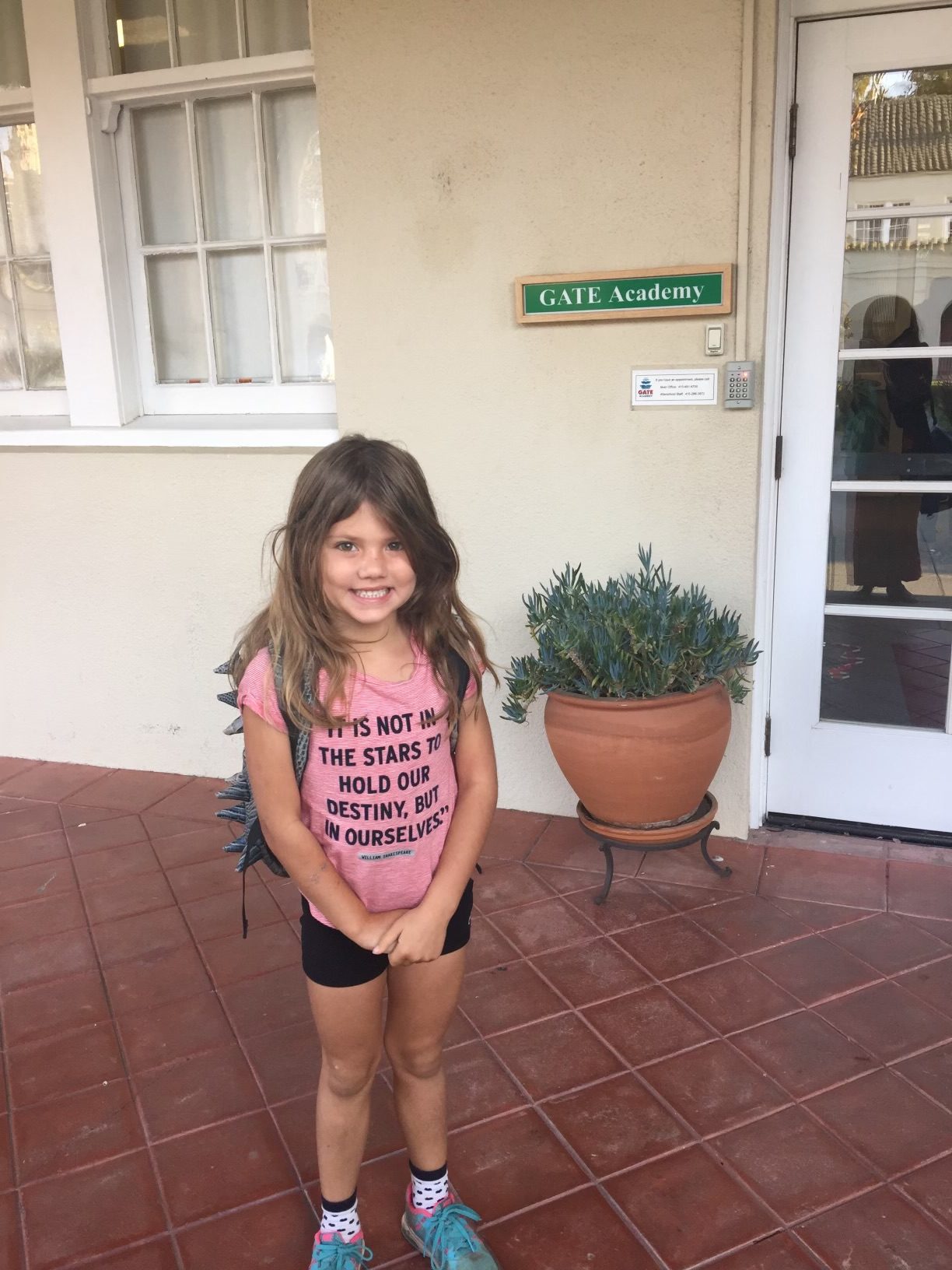 Stella as a child in front of GATE Academy