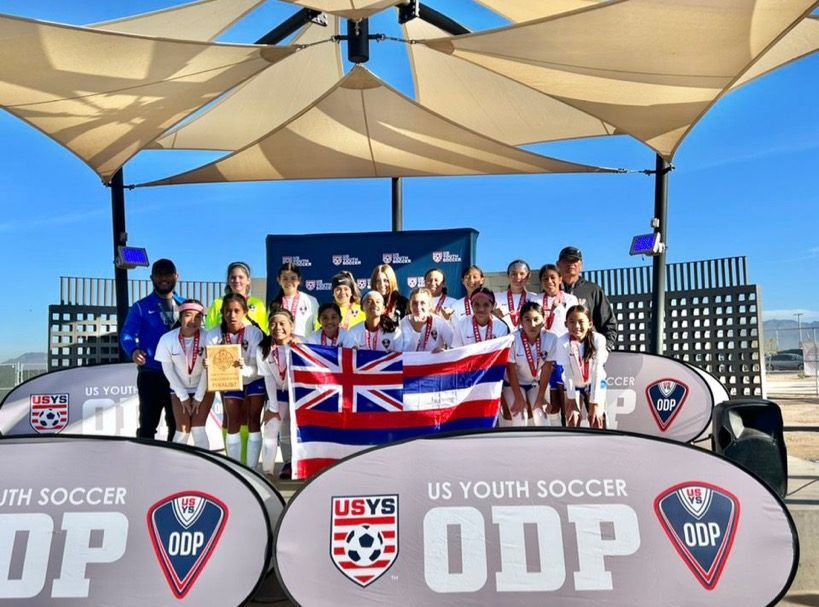 Hawaiʻi ODP team with the state flag and medals