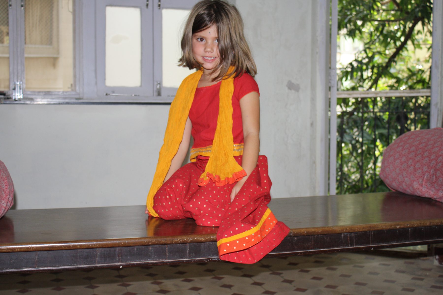 Stella as a child wearing traditional Indian clothing