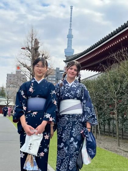 Stella and a friend in yukata with Tokyo Skytree behind them