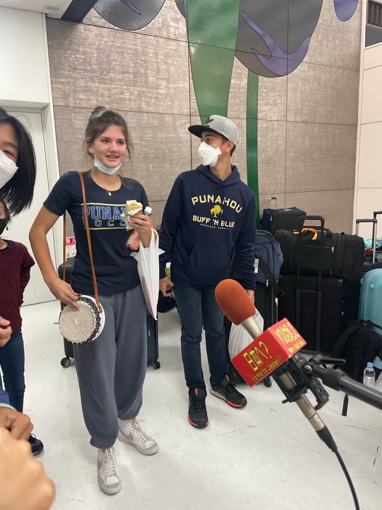 Stella being interviewed at the airport before traveling to Japan