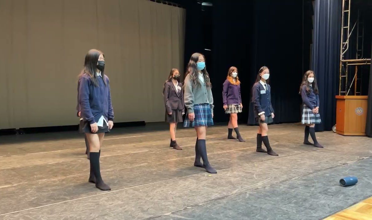 Dance club students on stage during the Chino school visit