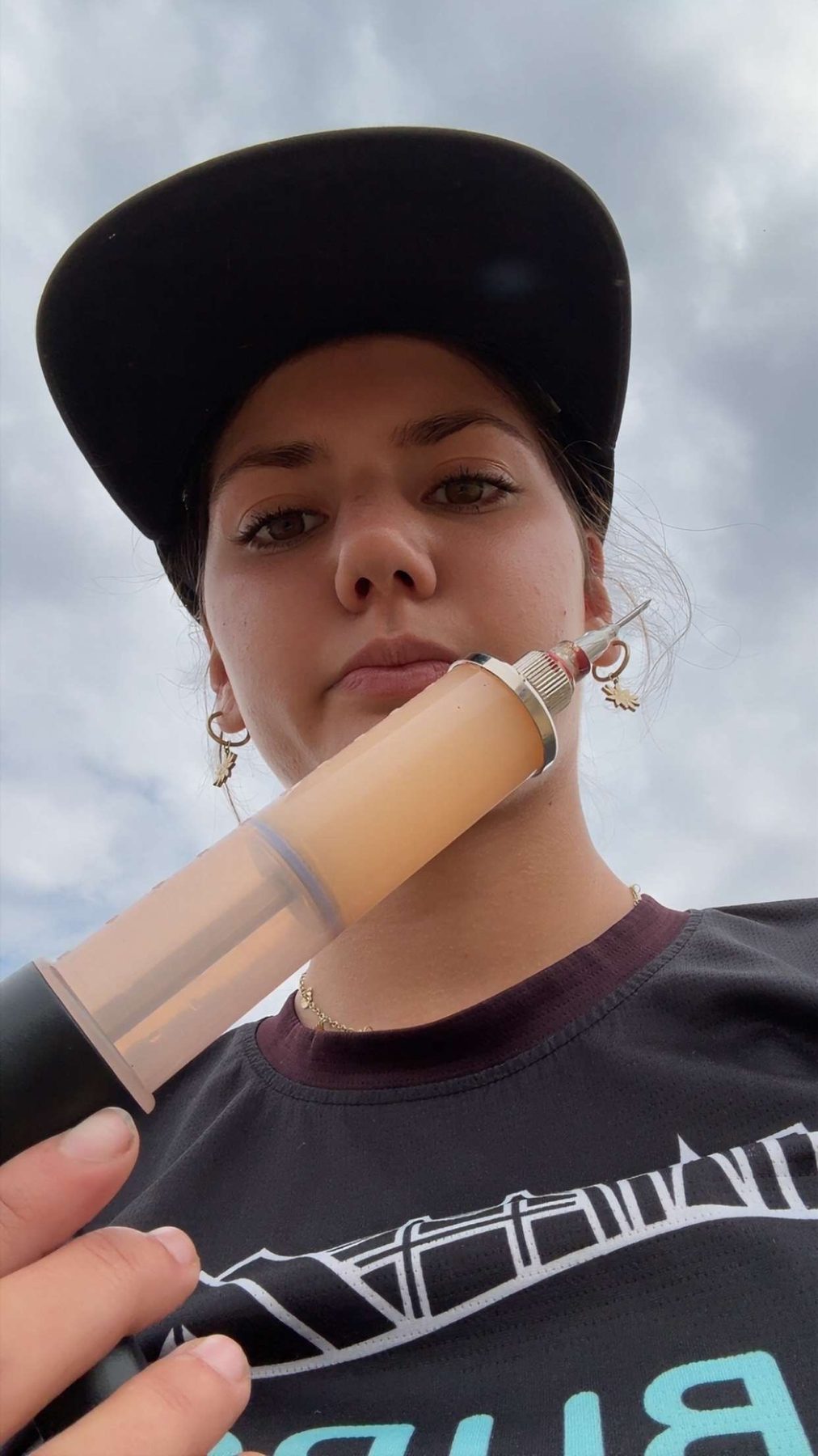Stella with a livestock vaccine syringe on branding day