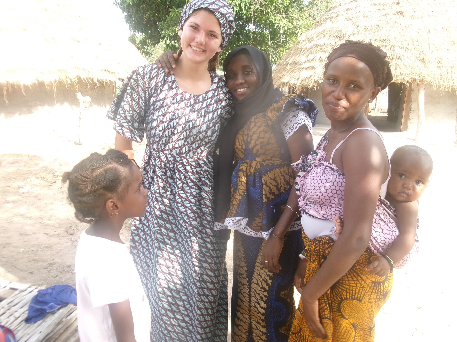 Stella with host family and neighbors in a village in Senegal