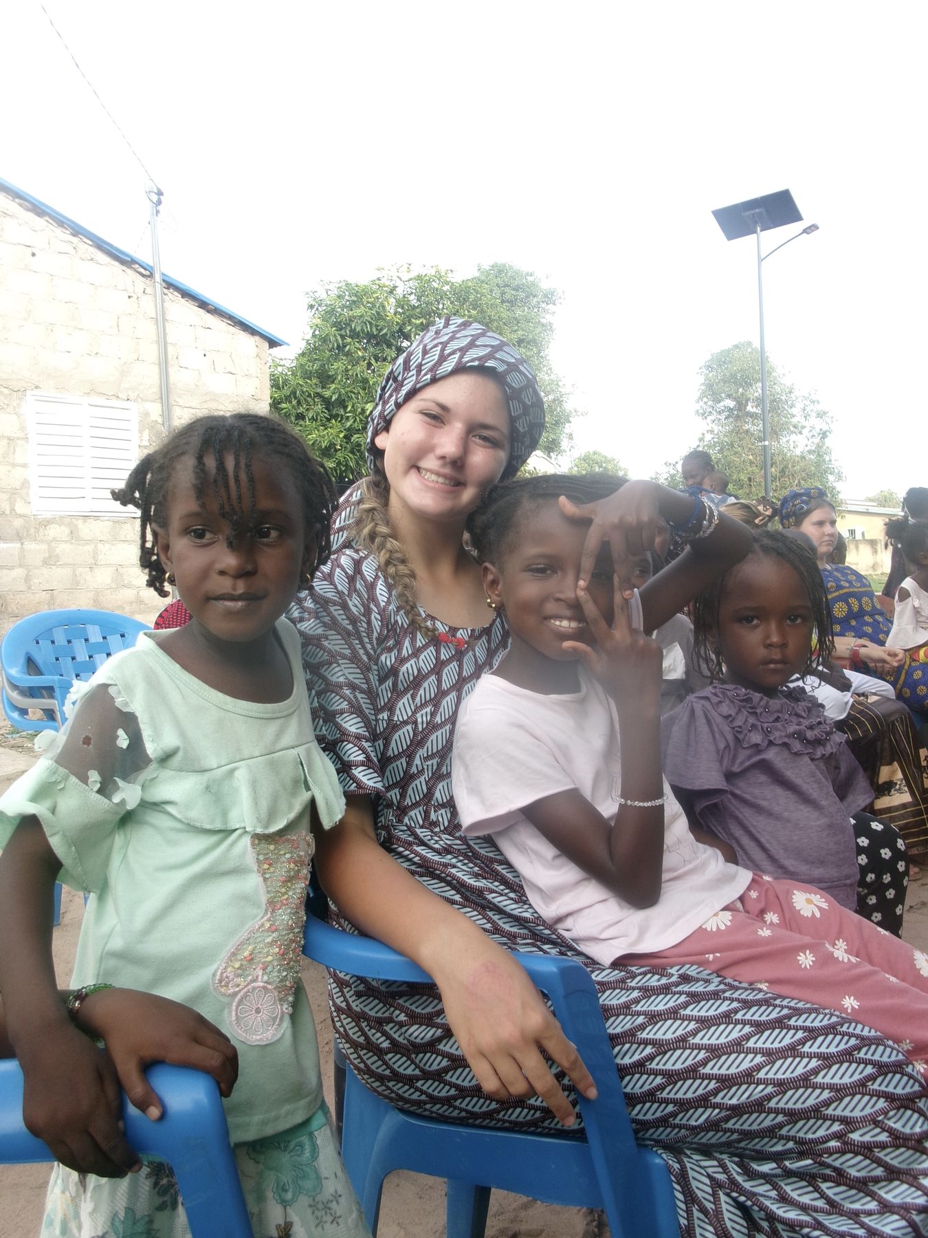 Stella sitting with children in Senegal